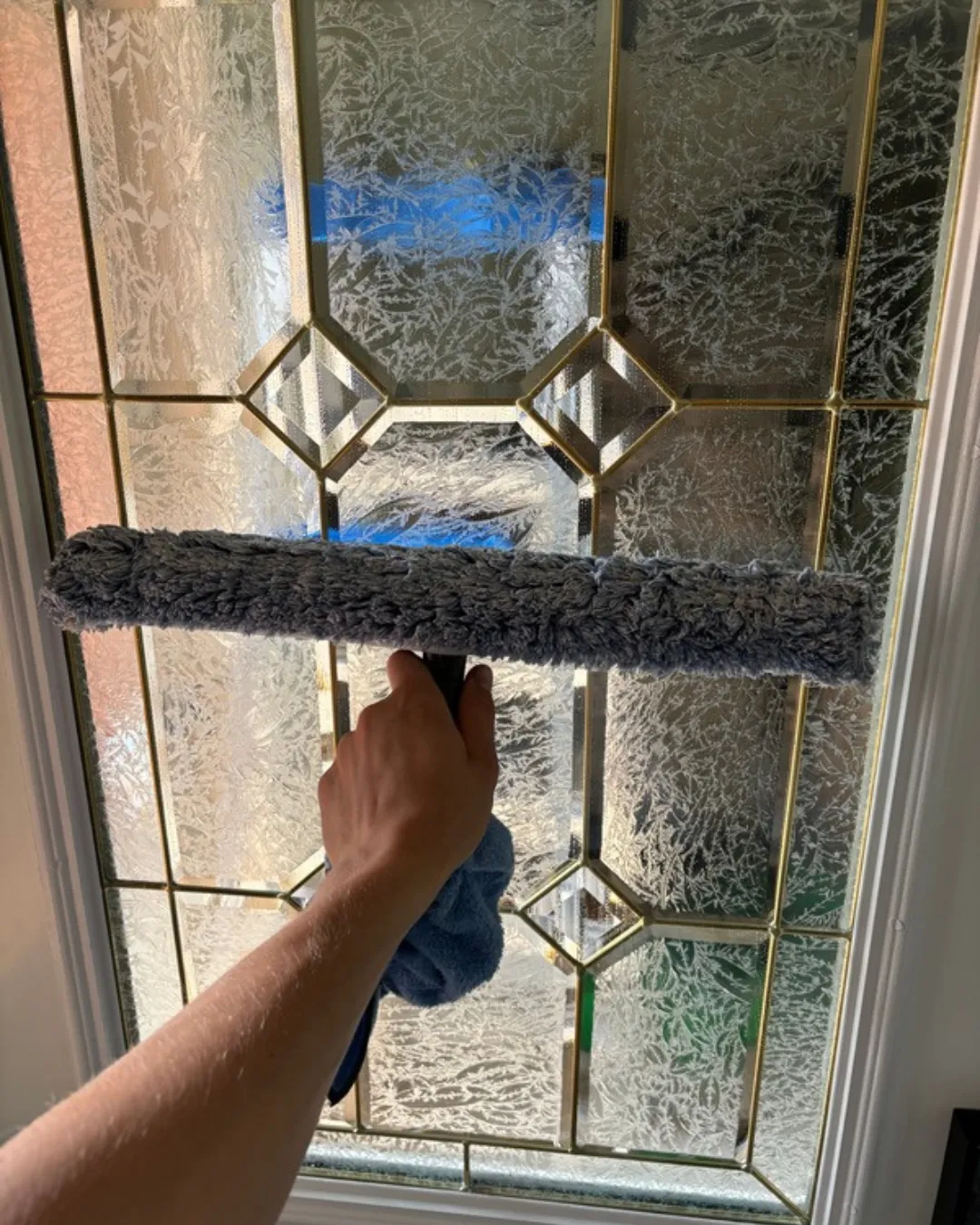 Streak-free window cleaning service on a residential home