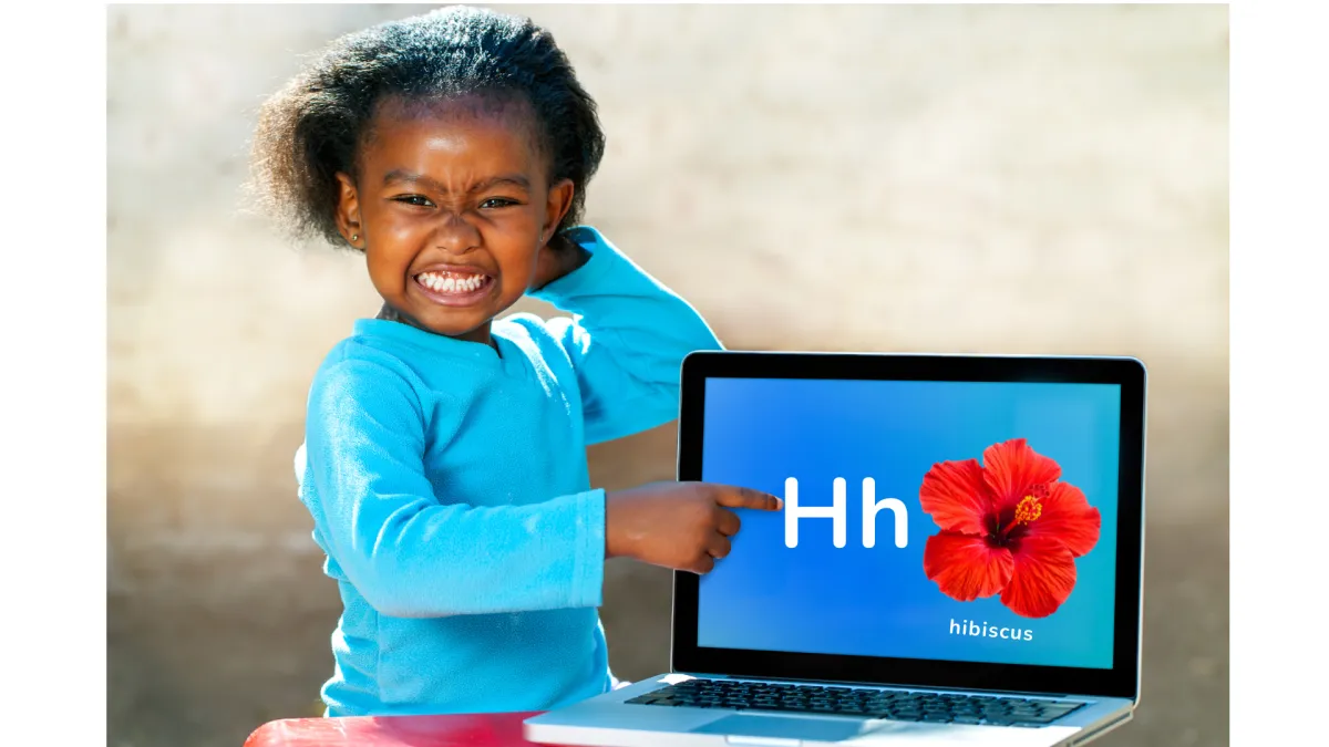 Girl watches a lesson about the alphabet on a laptop