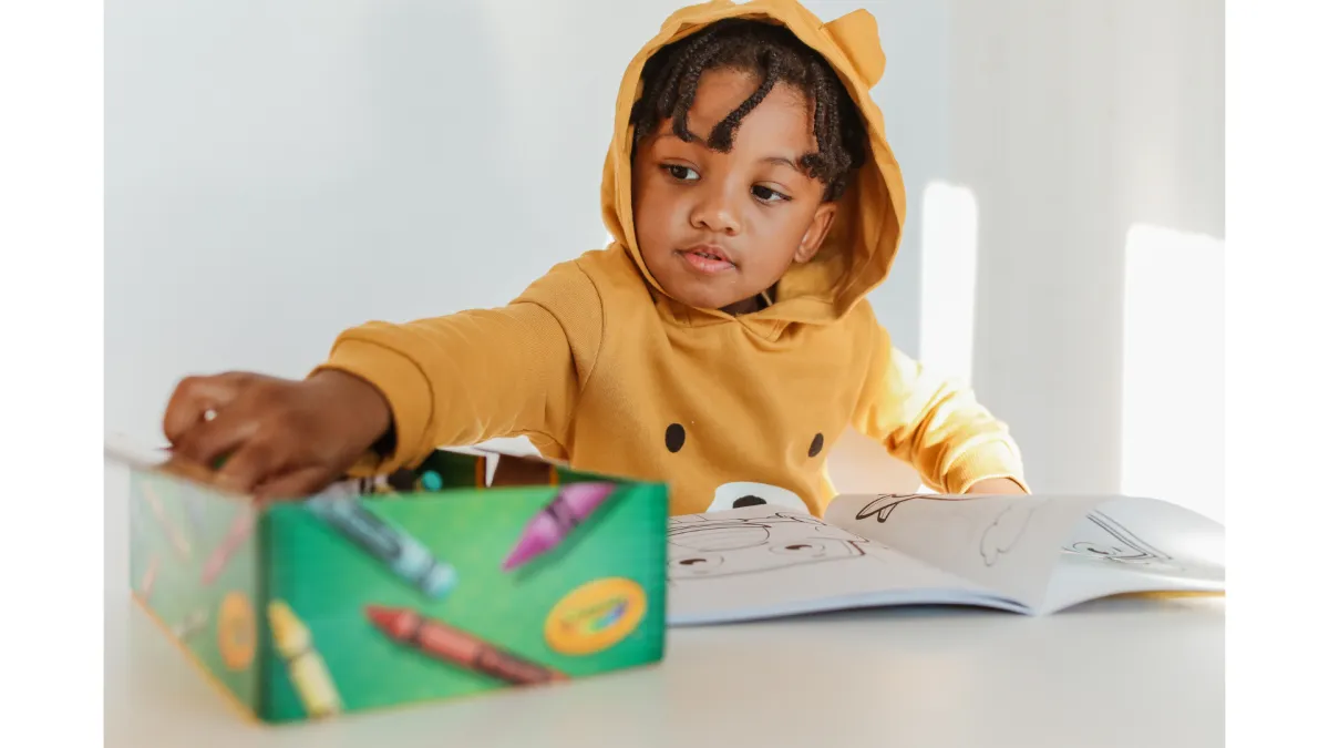 Girl follows directions during arts and crafts time.