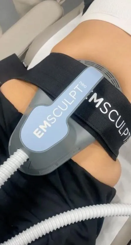 person in black shirt and blue denim jeans sitting on brown rock near body of water