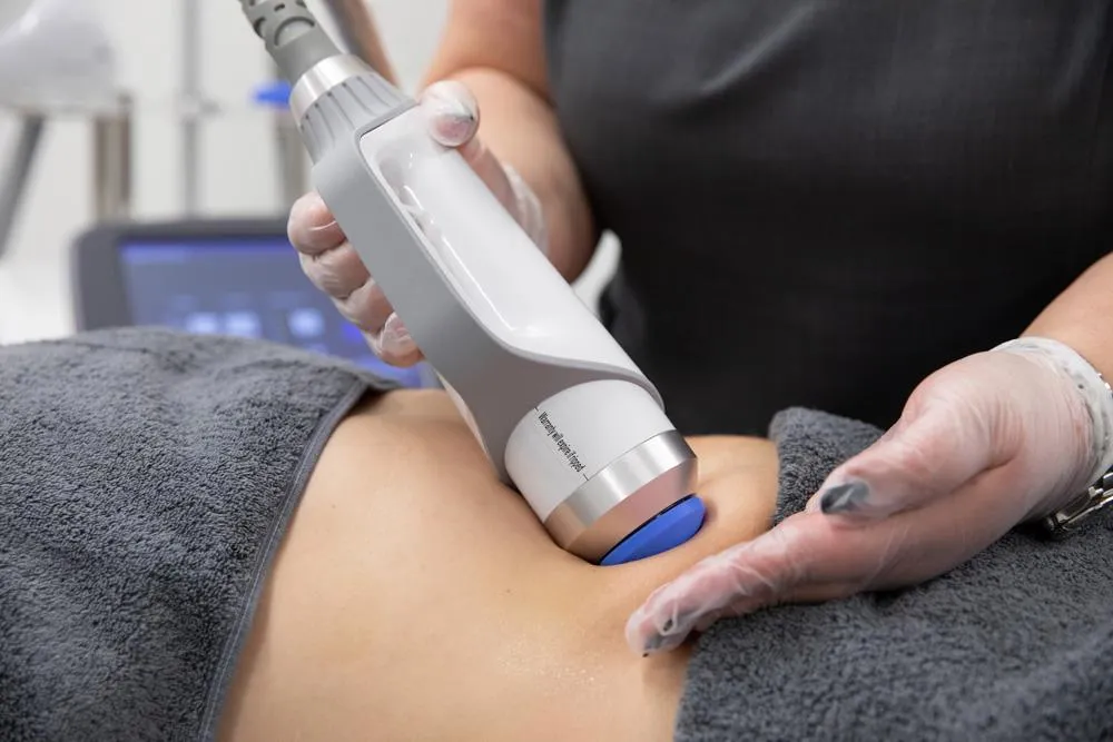 a grassy field with trees in the background
