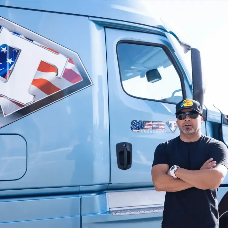 Heath Treasure, founder of Ultimate Blue Collar Insurance, standing confidently in front of a semi-truck, representing reliable insurance for truckers and blue-collar industries.