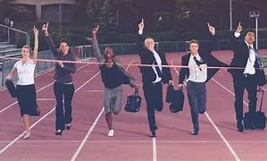 Business professionals in suits joyfully crossing a finish line, symbolizing success and achievement.