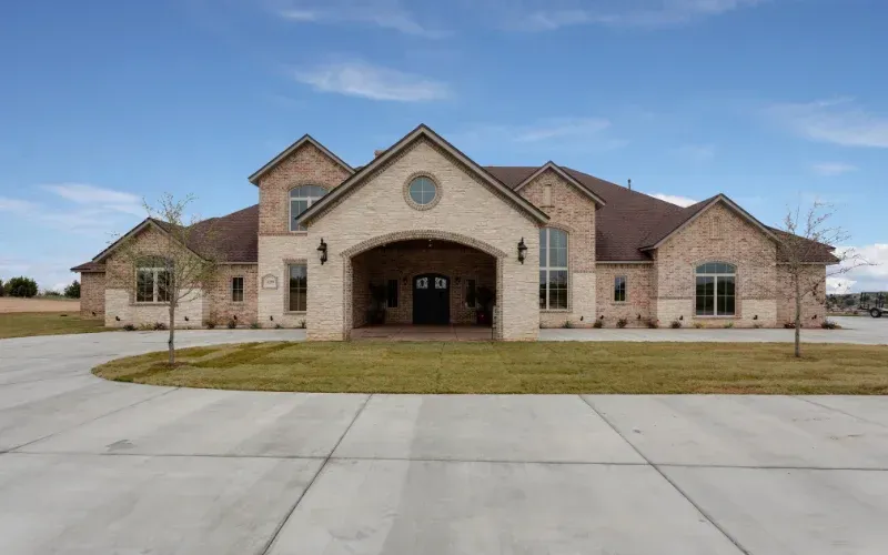 Large residential building with clean exterior and fresh landscaping