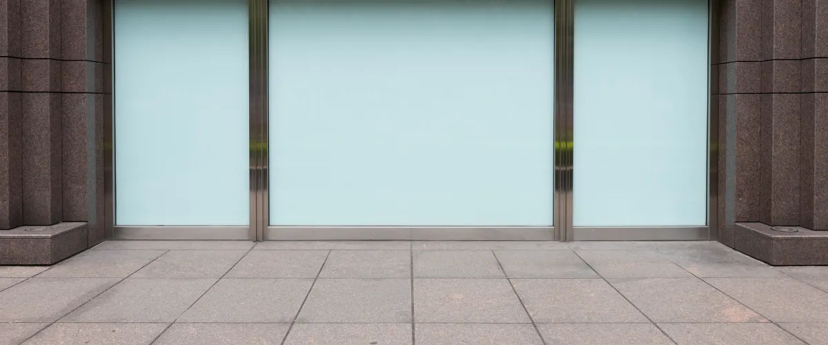 Front of commercial building with wide concrete sidewalk ready for pressure washing