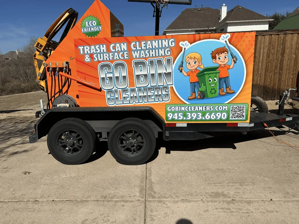 GO Bin Cleaners service truck with branded logo and residential trash bins lined up in front