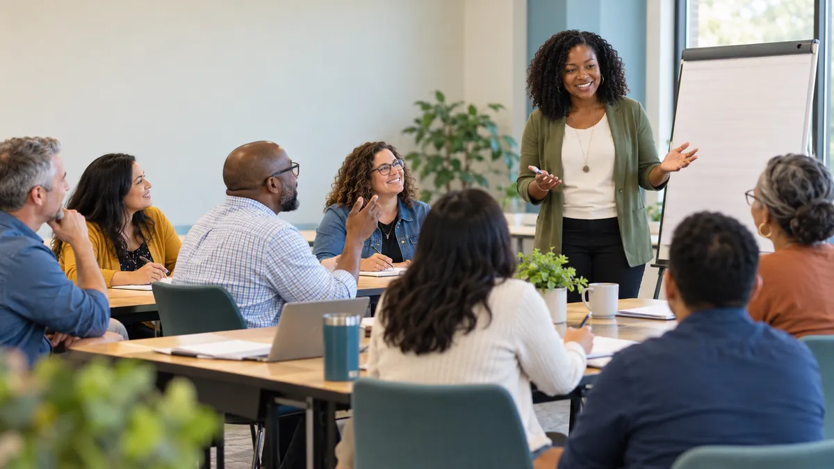 A facilitator leading a discussion with a diverse workshop group