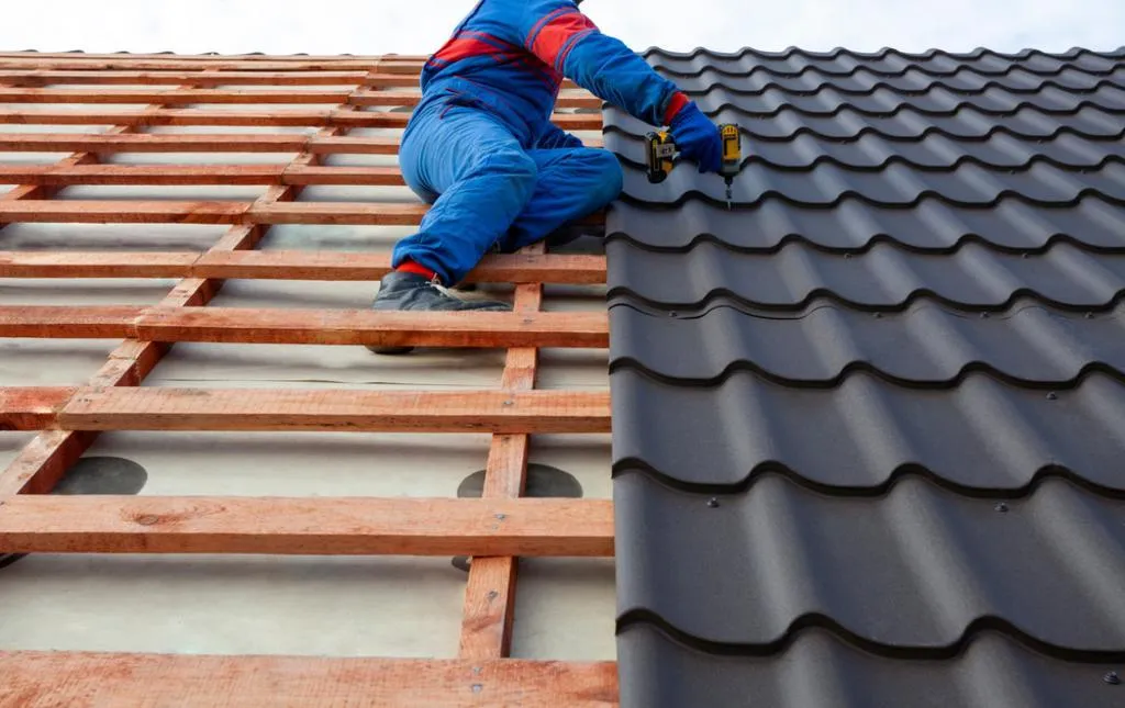 Close-up of a roofer at a side angle, carefully installing roof tiles into the framework, ensuring precision and durability, by JF Roofers.