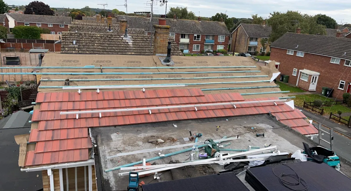 Halfway completed roof replacement in Worcester by JF Roofers, showcasing expert installation of new roof tiles, ensuring quality workmanship, durability, and enhanced protection for the home.