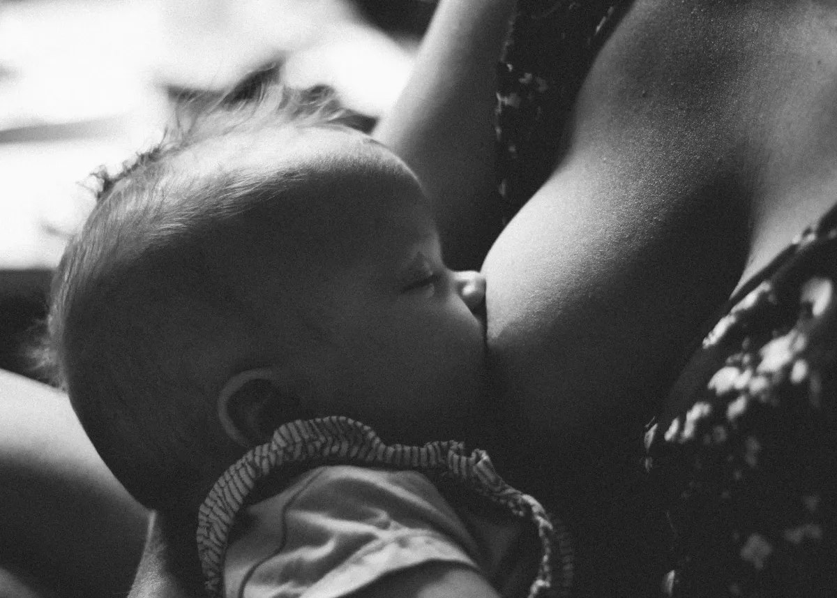 Mother receiving lactation and breastfeeding support with her baby