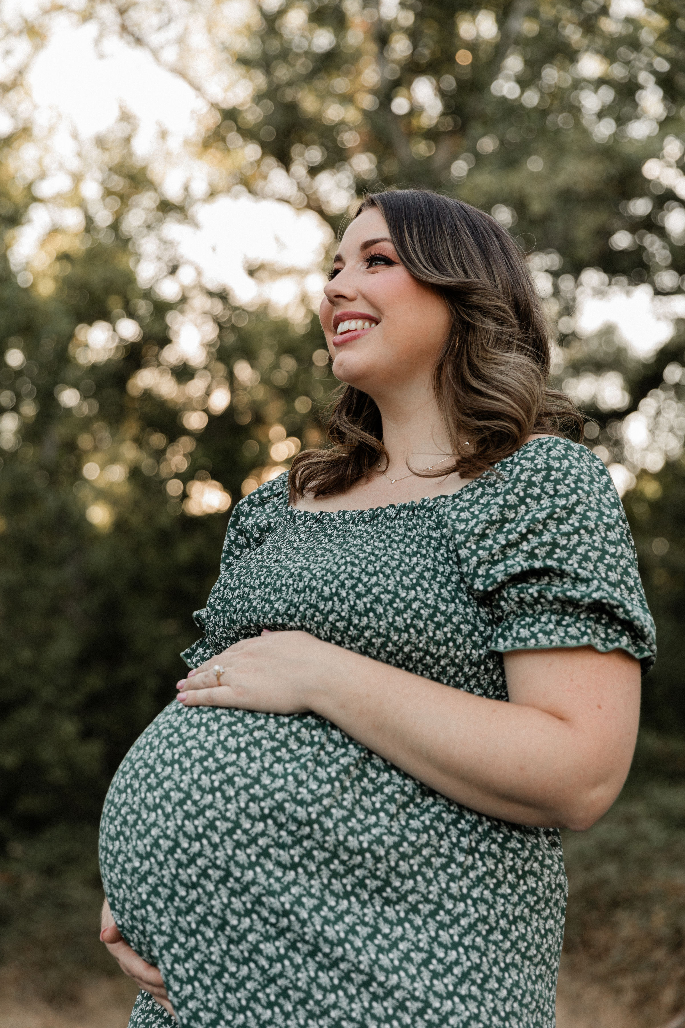 Pregnant mother in a green dress representing pregnancy and birth support from Modesto Birth & Beyond