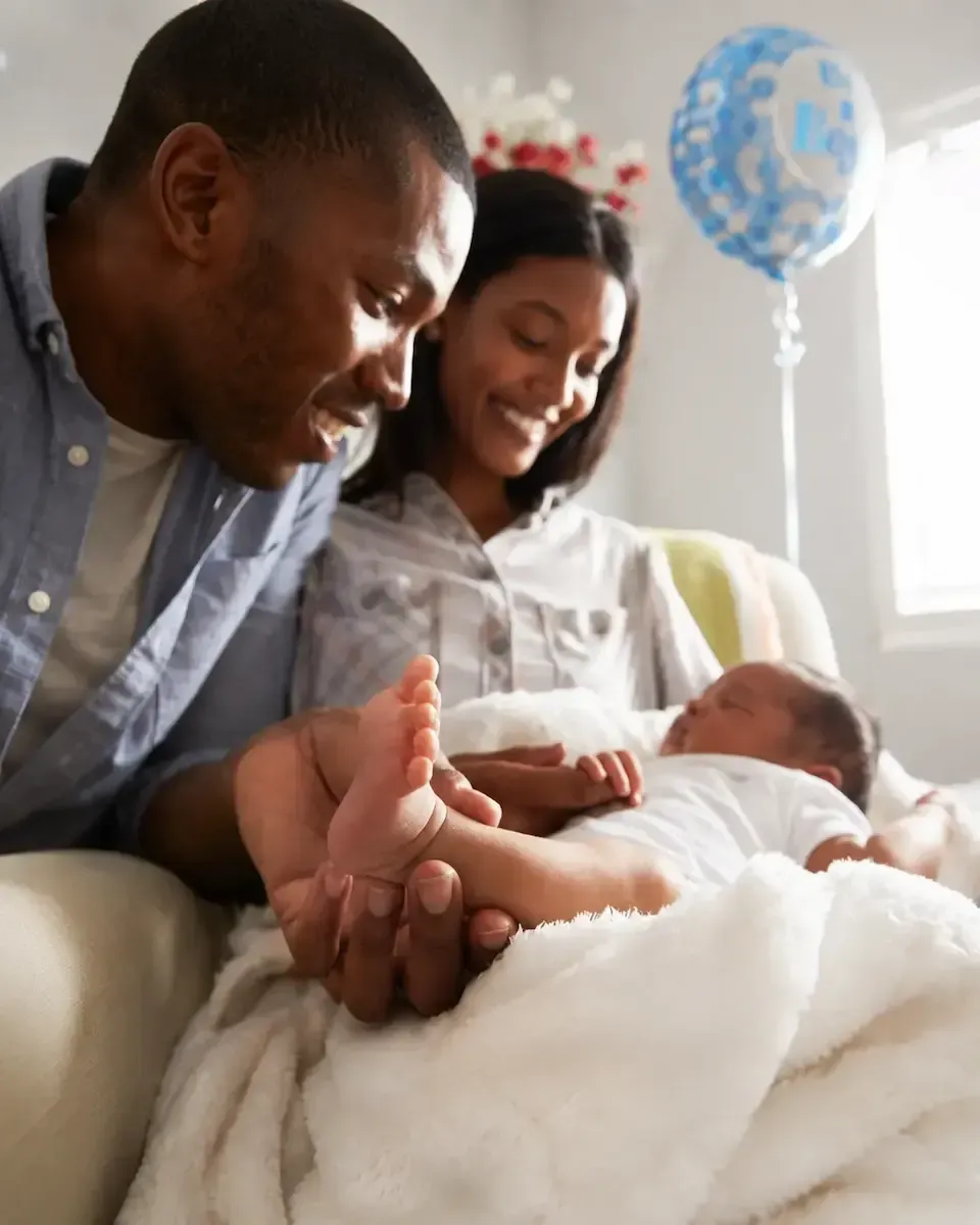 Mother and newborn receiving postpartum doula support at home