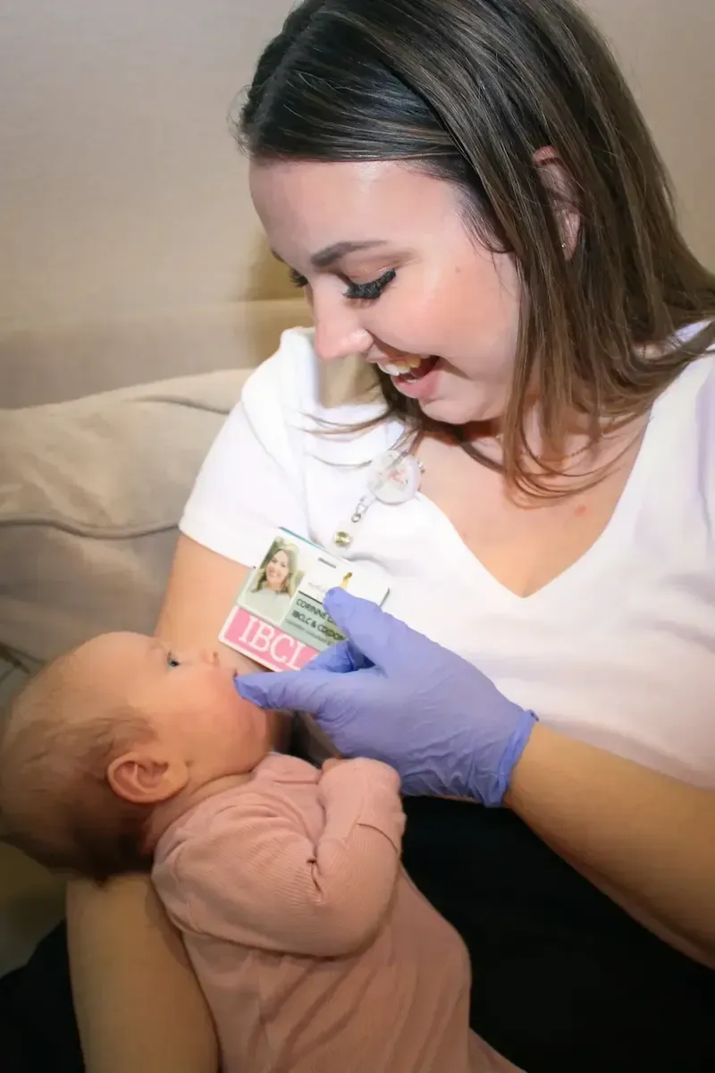 Mother receiving breastfeeding and lactation support with her baby