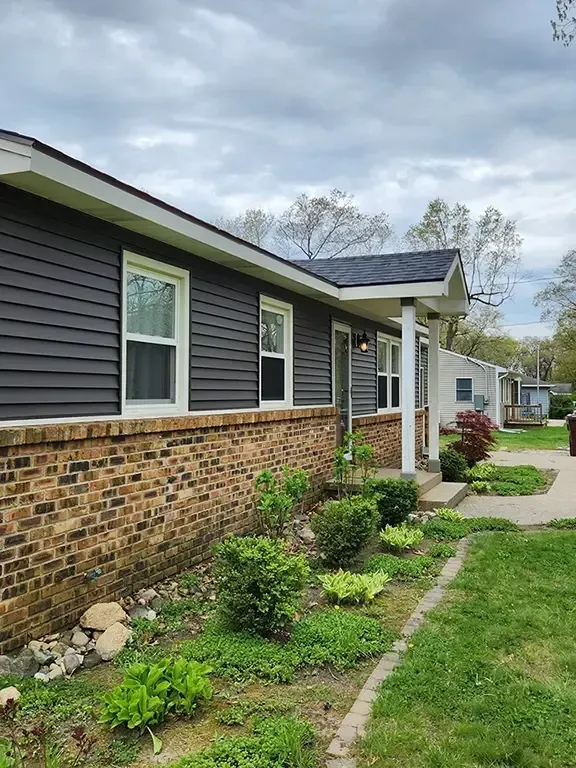 Single-story home with newly installed asphalt shingle roof and updated siding