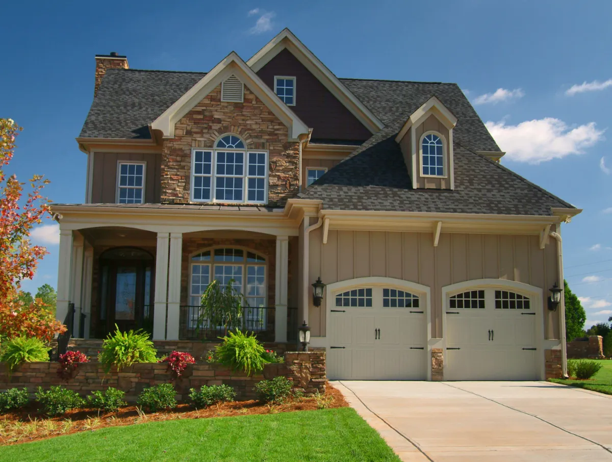 Professional handyman repairing kitchen cabinet in modern white kitchen providing expert home repair and maintenance services for homeowners in North Carolina