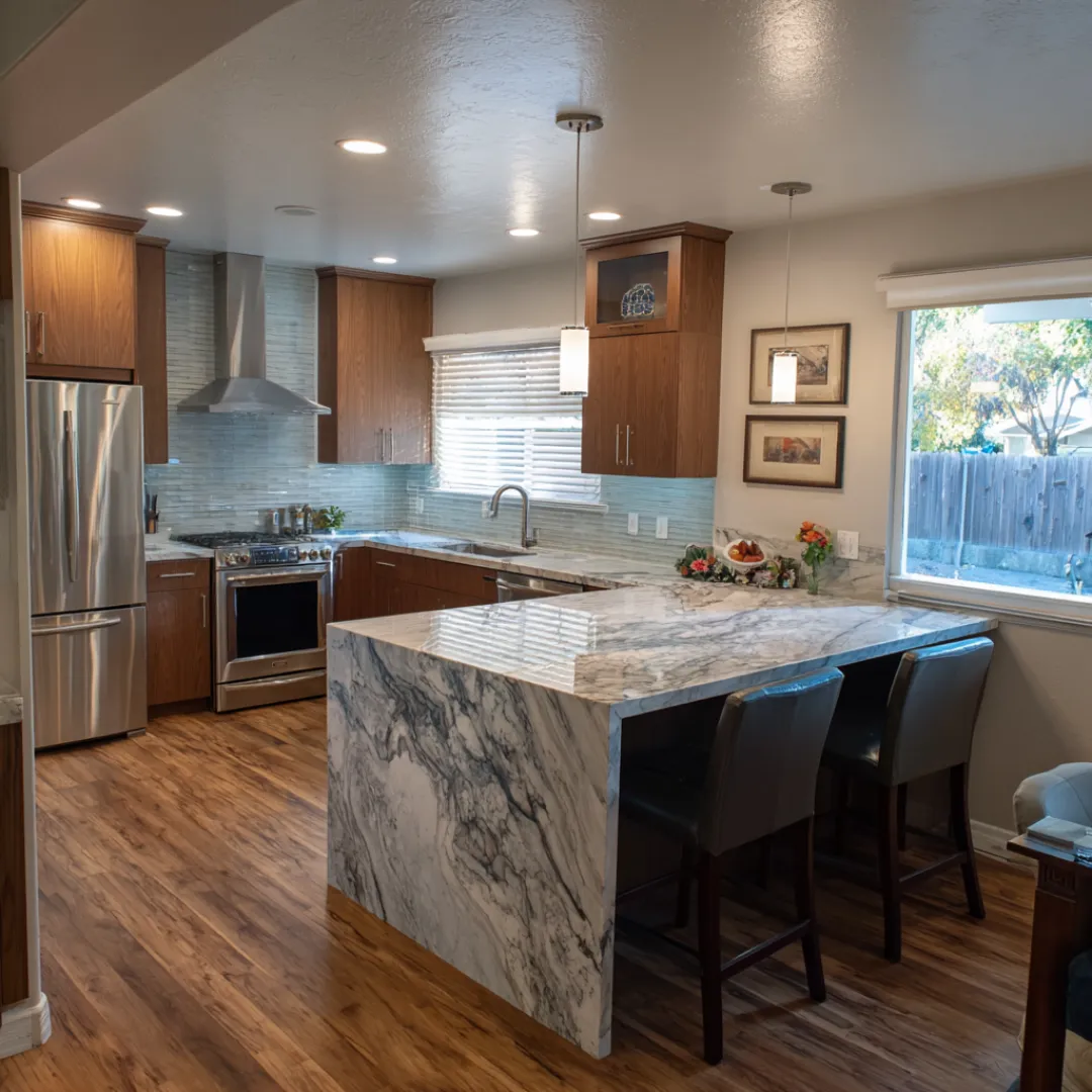 Spacious remodeled kitchen with granite countertops shaker cabinets hardwood floors and stainless steel appliances designed for modern family living