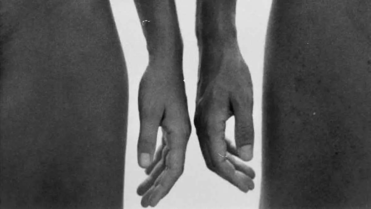 Close-up of couple’s hands touching, evoking intimacy and vulnerability in Two Perspectives series
