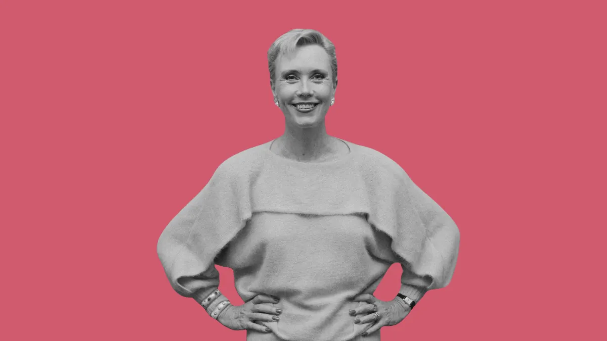 Black-and-white portrait of Nancy Friday on a bold red background, representing the origin of Her Secret Garden, a collection of women’s sexual fantasies explored by Fruit & Flowers and The Juicy Times.