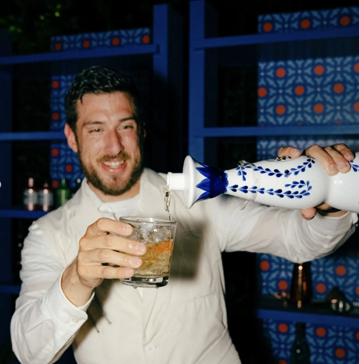 A waitress carries cocktails on a tray.
