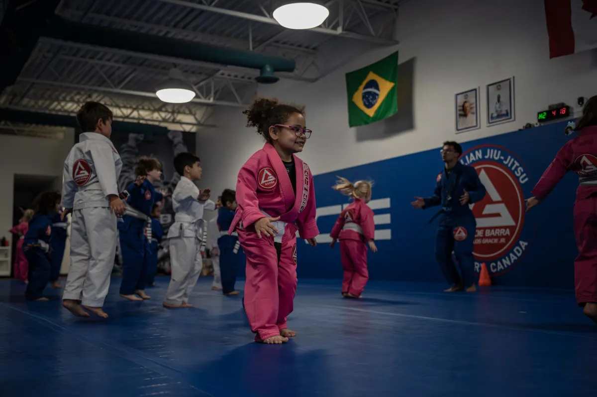 woman in gray tank top and black pants sitting on floor