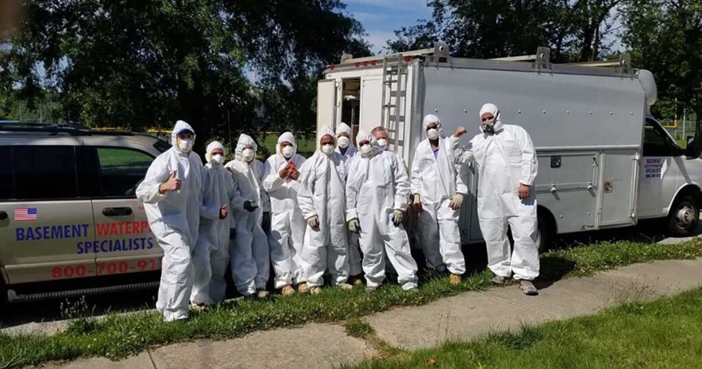 Technician inspecting mold in a basement for a local family