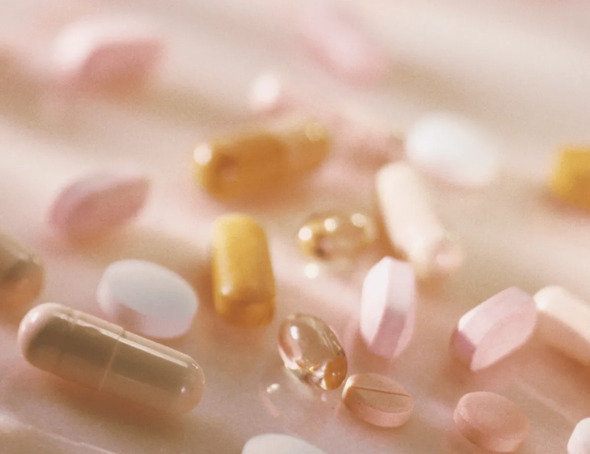 a black plate topped with three figs and a leaf