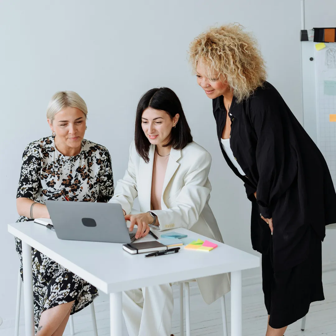 a black plate topped with three figs and a leaf