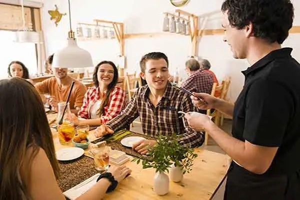 Image of a vibrant local restaurant with patrons enjoying meals, showcasing a cozy dining atmosphere and delicious food options.