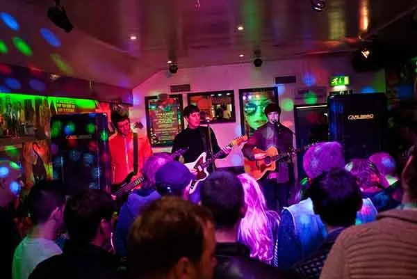 Image of live entertainment at a local venue, featured on the Always Local app, showcasing musicians and performers enhancing the dining and social experience at bars, restaurants, and breweries.