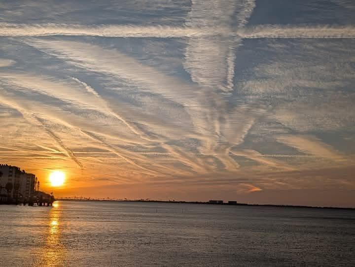 chemtrails over the ocean sunset