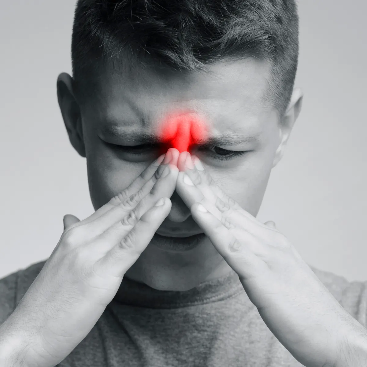 Man with allergies holding tissue