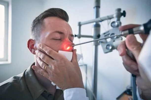 Man with allergies holding tissue
