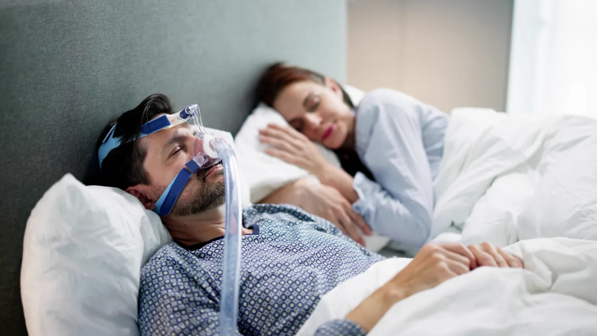 Man with allergies holding tissue