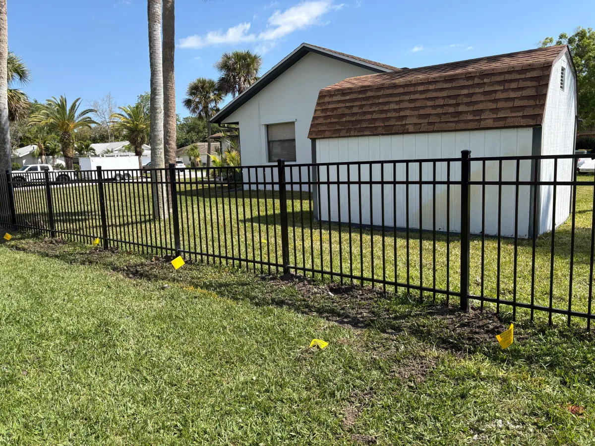 A close up of a metal fence with a blue sky in the background