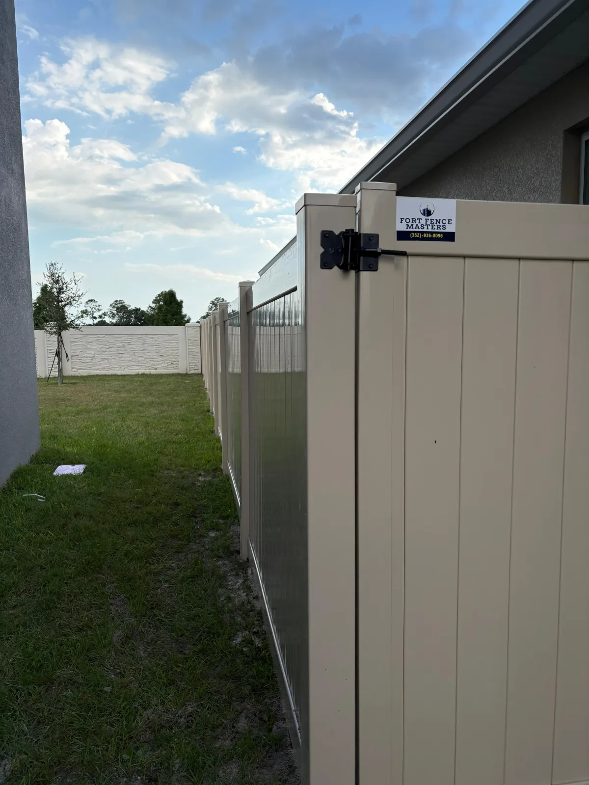 a black iron fence with green moss growing on it