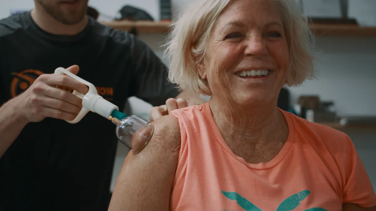 Physical therapist applying therapeutic cupping on an athlete's back
