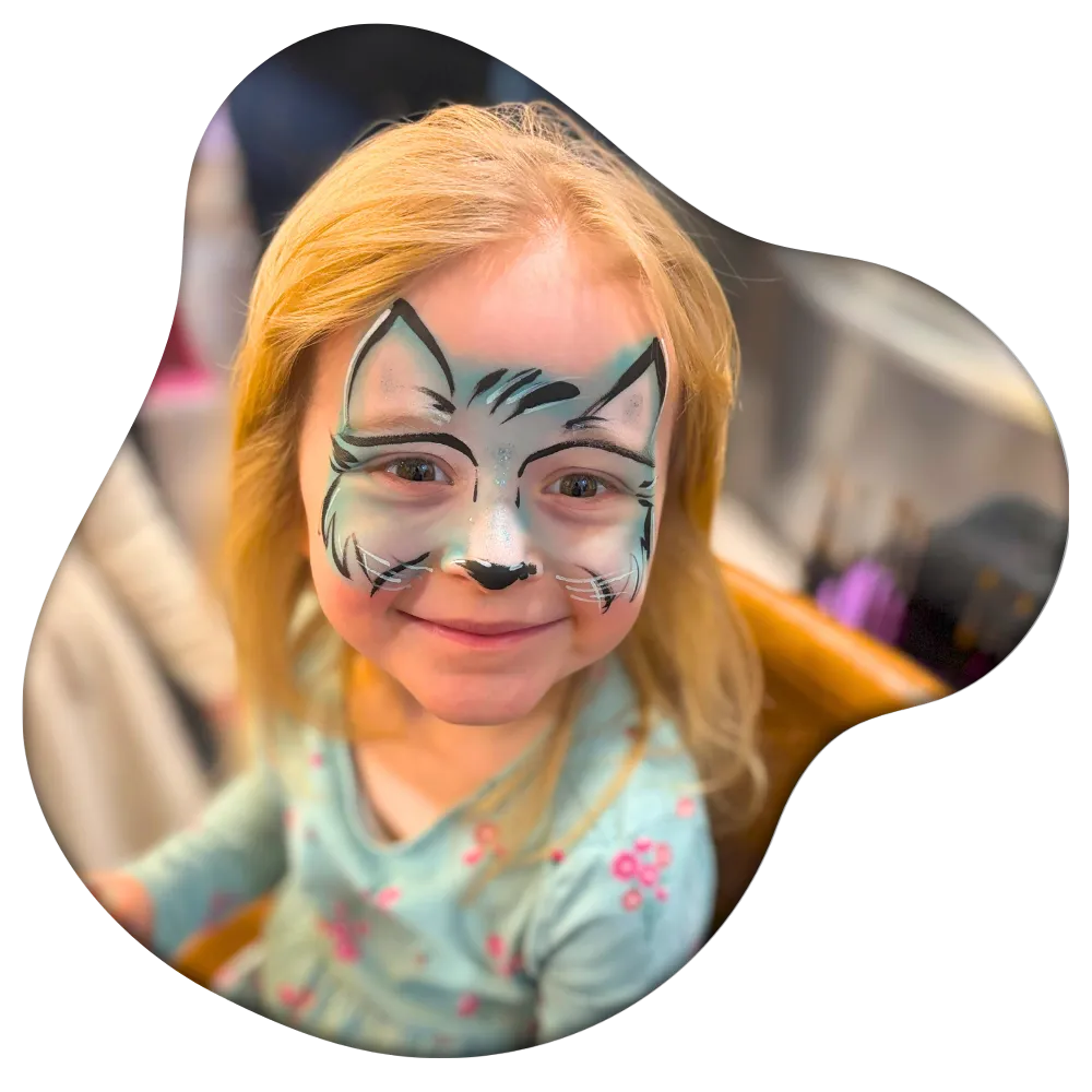 Professional artist from Aria Face Artistry providing high-end face painting at a Central Ohio event