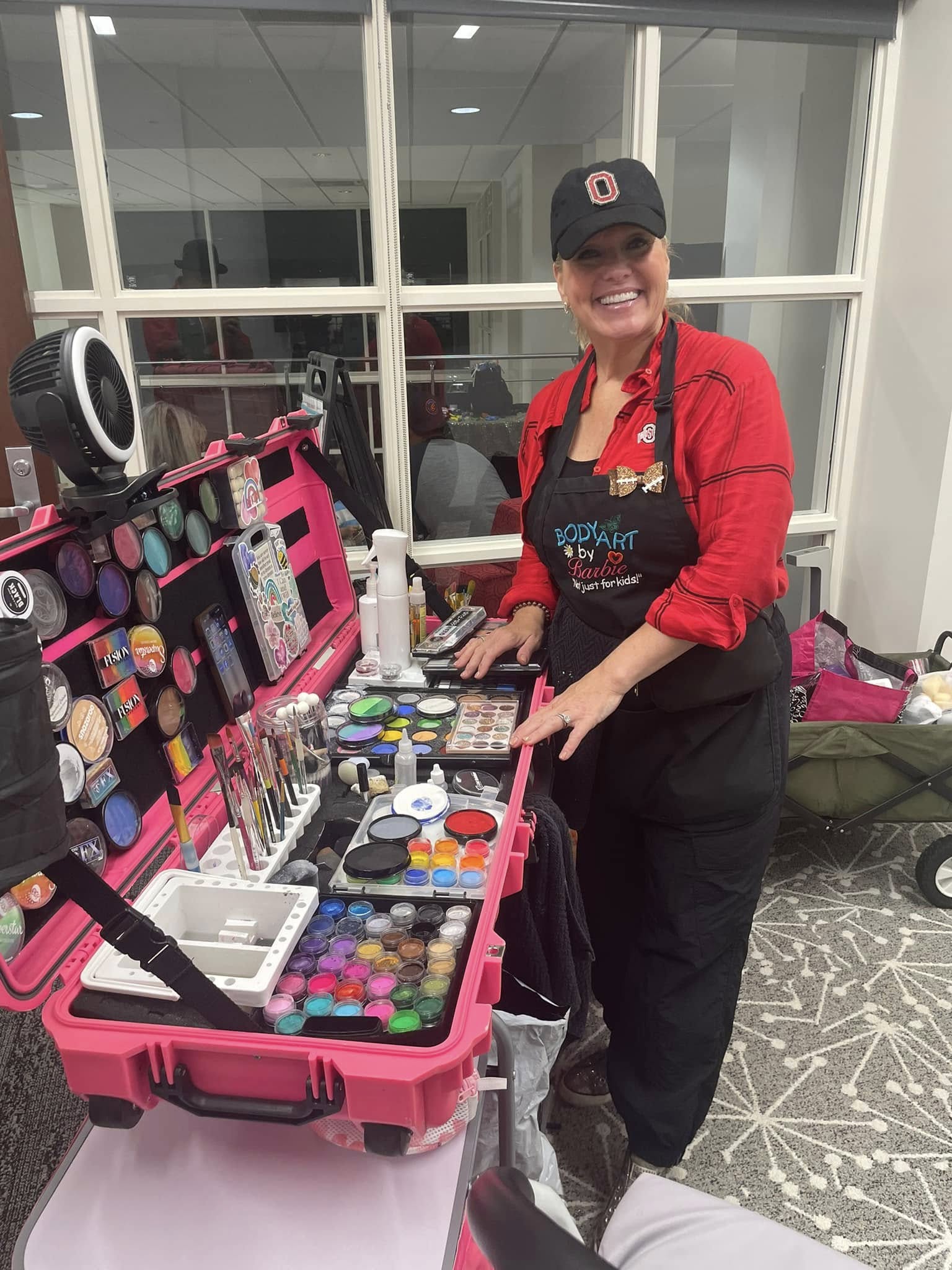 Professional event artist in Central Ohio prepared with an organized, high-quality face painting kit for a birthday party.