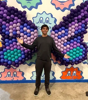 Ishan, Lead Balloon Architect for Aria Face Artistry, creating custom balloon sculptures in Central Ohio.