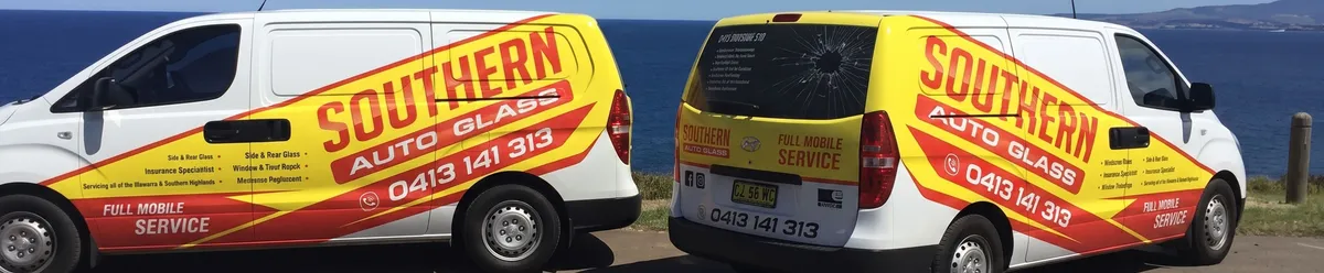 Two Southern Auto Glass mobile service vans parked by the Illawarra coast — full mobile auto glass service across Wollongong