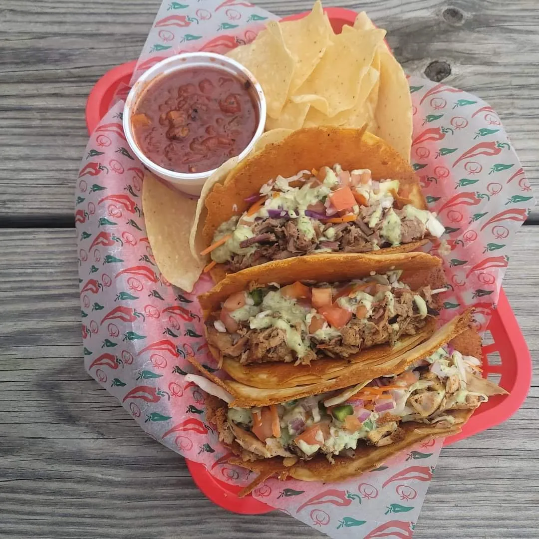 Three loaded BBQ street tacos with slaw and pico de gallo, served with tortilla chips and salsa at Link’s at Chaffee Crossing