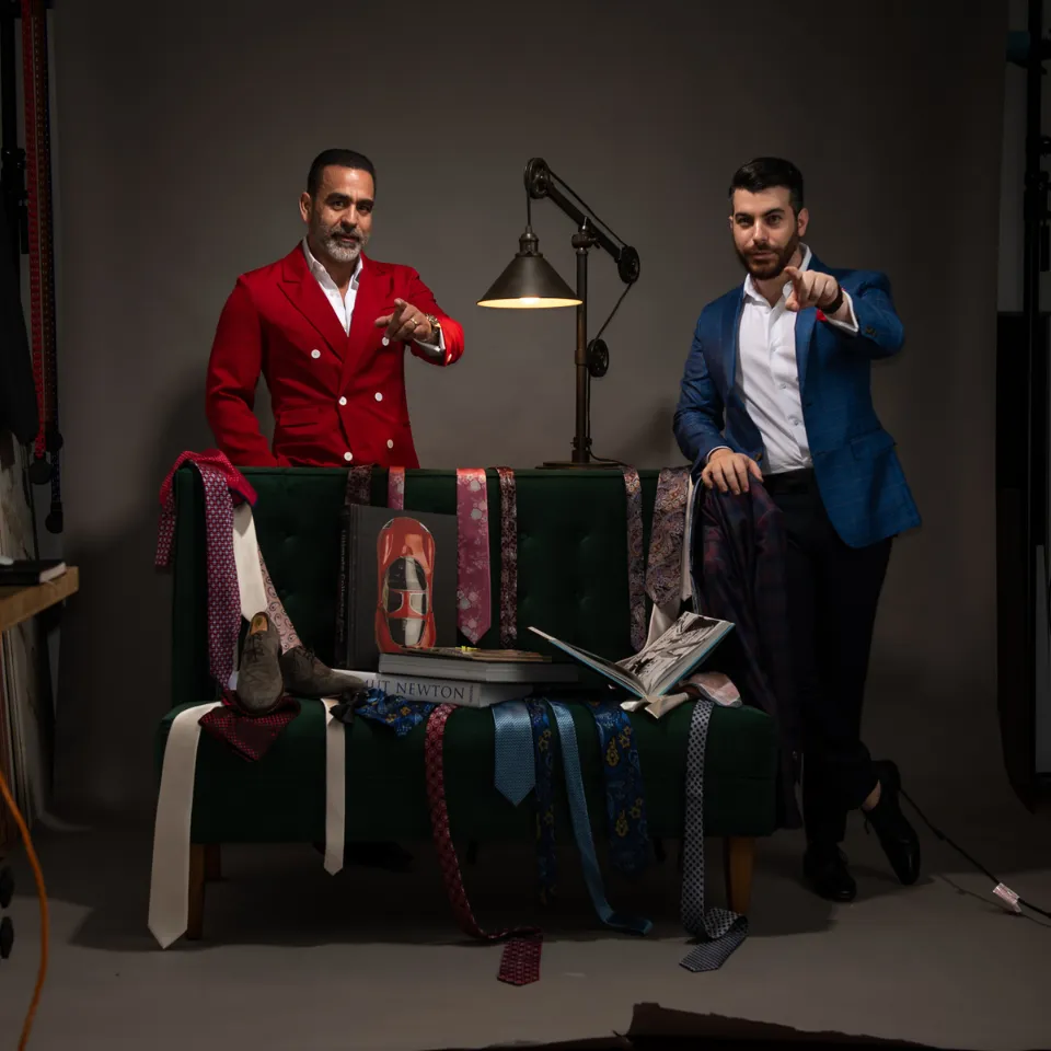 The owners of the house of suits Ivan & Abi next to a collection of multi colored Italian Suit ties