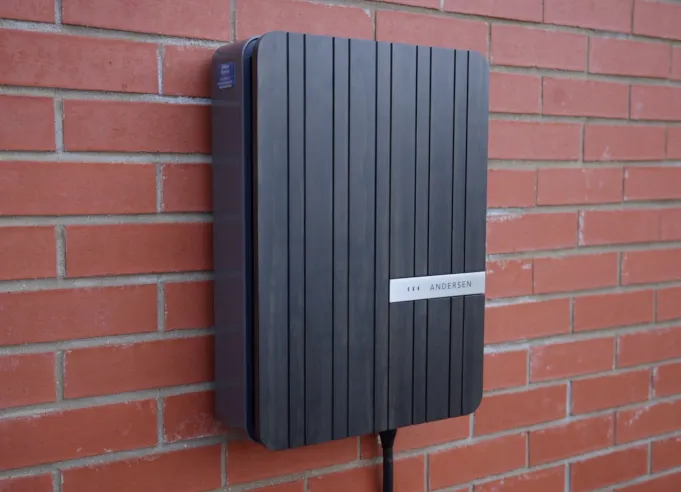 Wall-mounted EV charger professionally installed at a residential property with tidy cabling solar system design