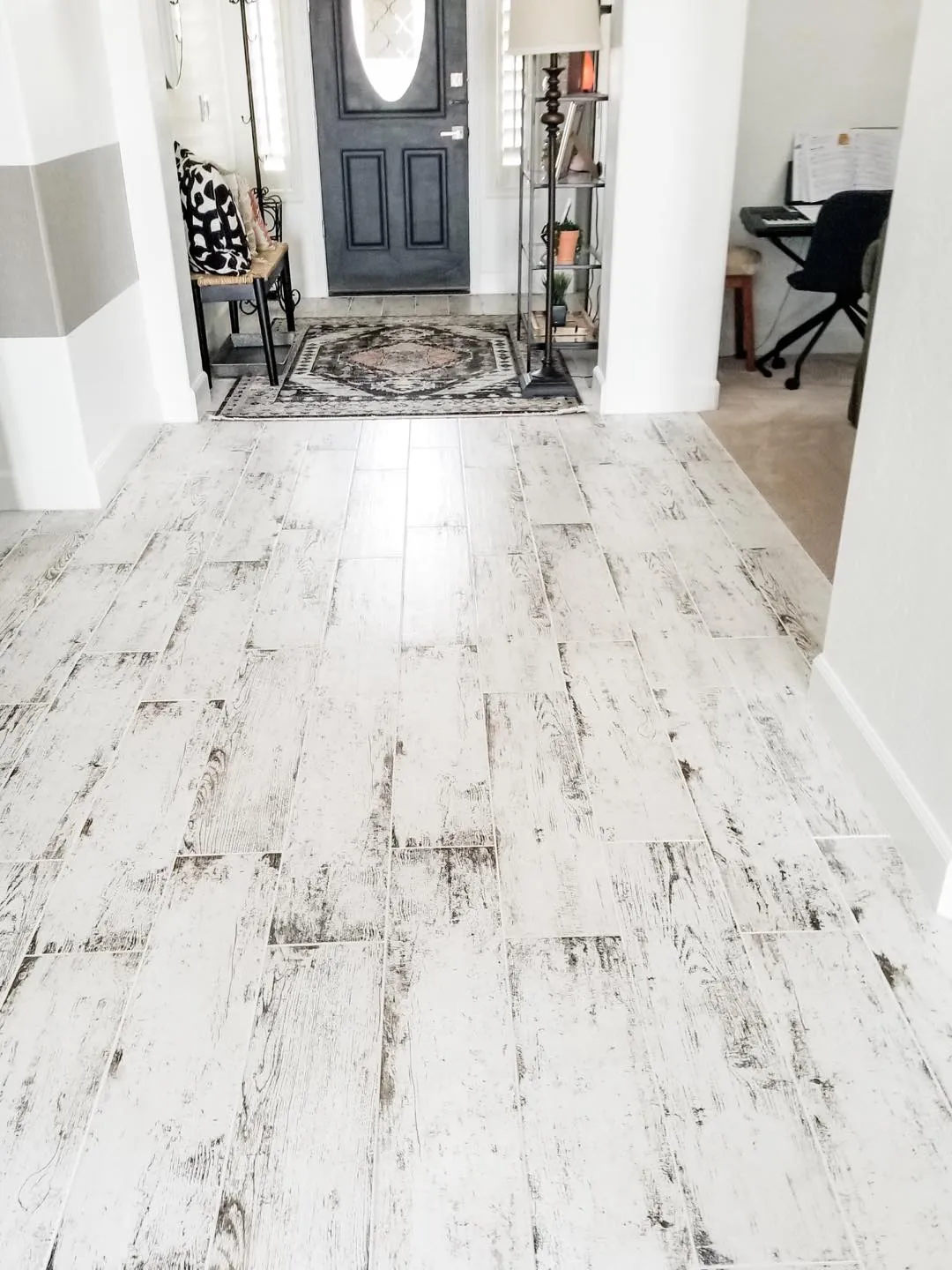 White and gray LVP plan floor installed by advanced custom renovations