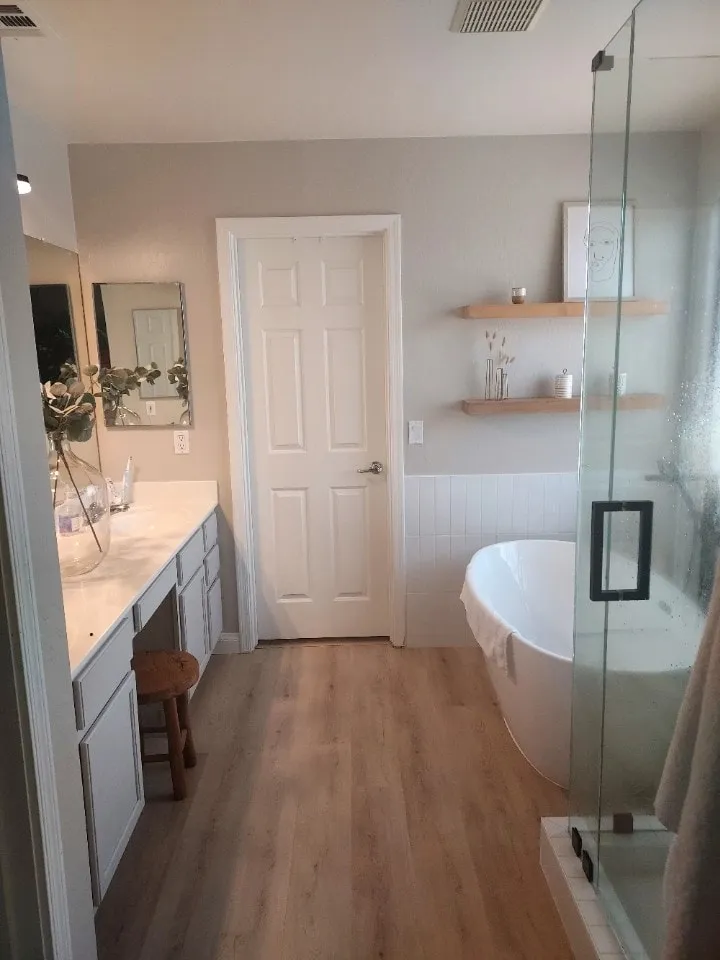 Primary bathroom remodel with new shower and glass, freestanding tub, and new LVP flooring