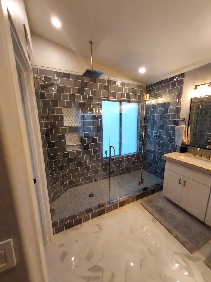 primary bathroom with large shower, full glass,tile floors