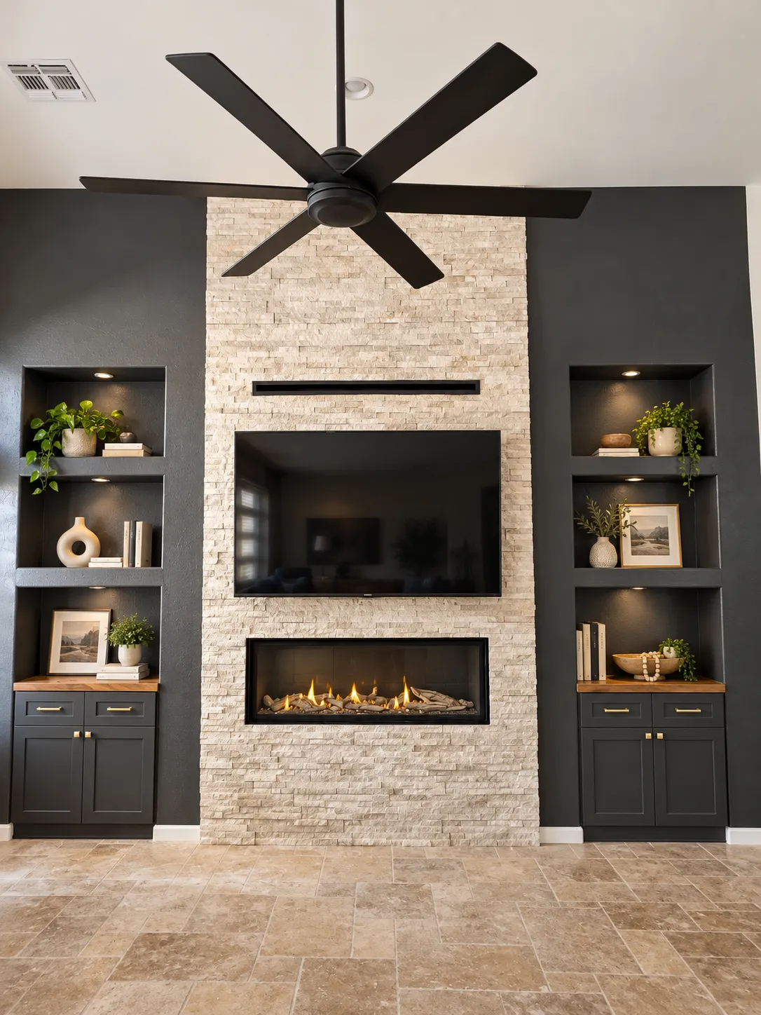 media wall with stacked stone tile, storage cubbies on the left and right,low profile fireplace beneath a mounted tv