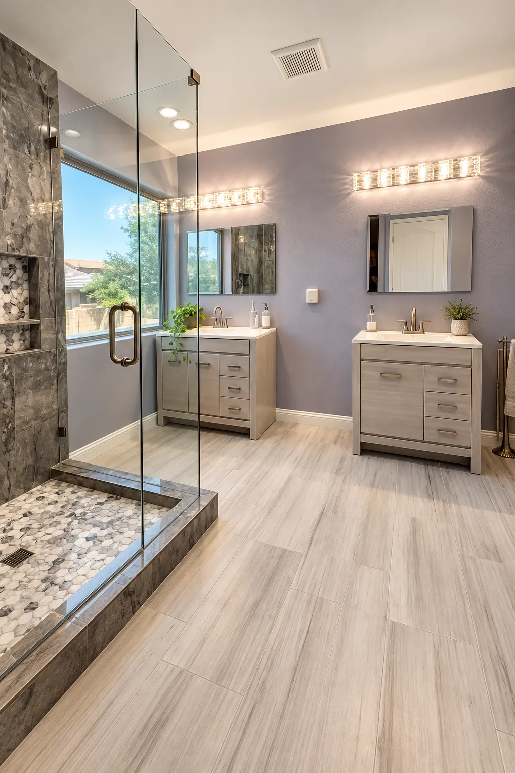 full primary bathroom remodel with two vanities, custom hex tile and glass