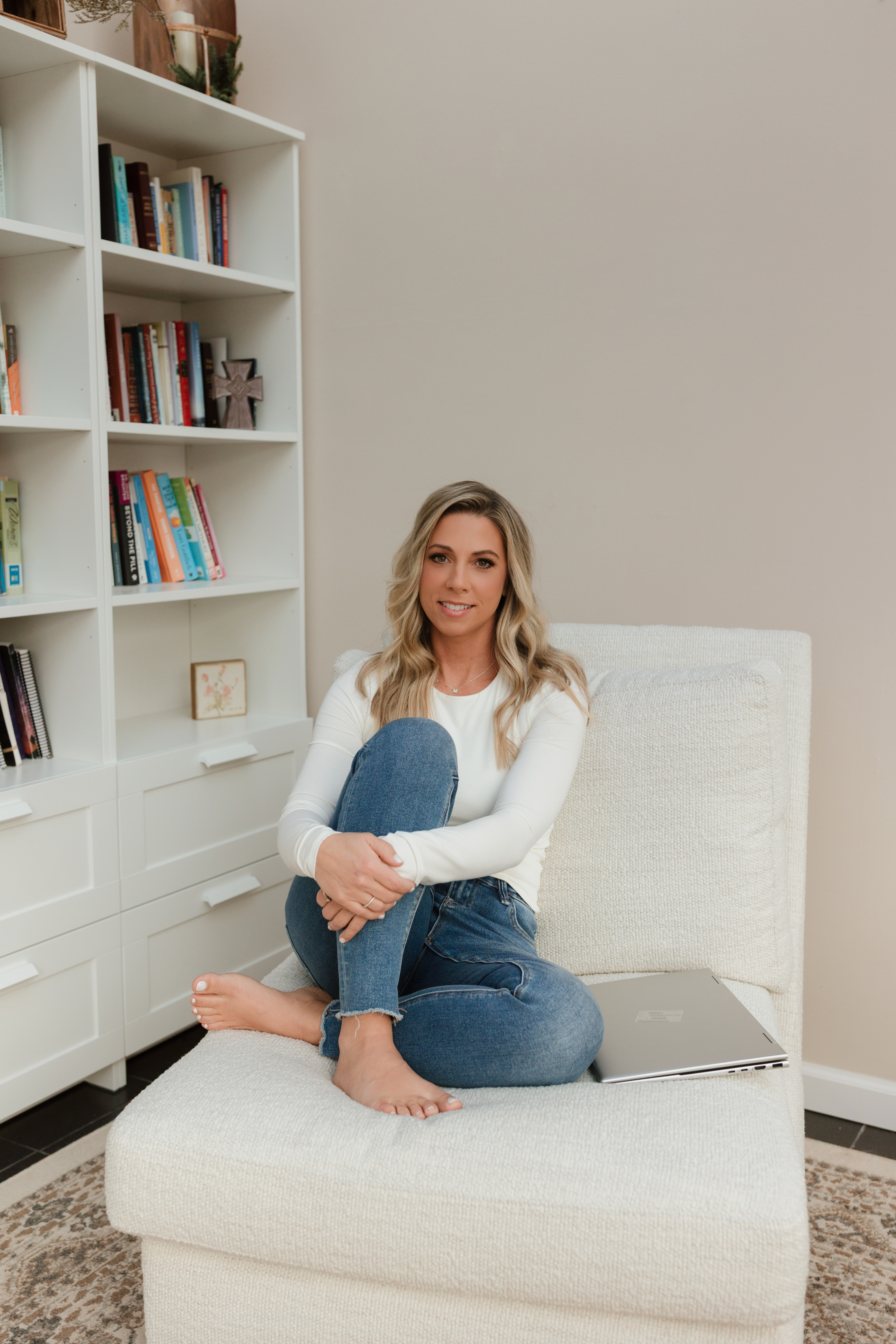 Portrait of Pamela, a mid-30s professional woman in a relaxed pose in a neutral-toned environment.