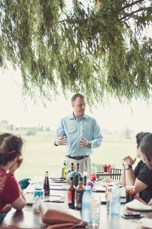 Pieter speaking at a casual outdoor team building session.